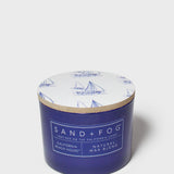 Blue scented candle jar with sailboat lid and SAND+FOG California Beach House label