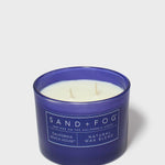 Blue scented candle in glass jar, SAND+FOG label and natural wax blend