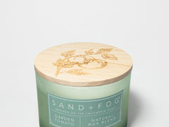 Green candle jar with wooden lid and SANDFOG label on front
