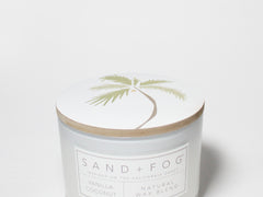 Scented candle jar with palm tree lid and SAND+FOG label