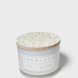 SAND+FOG scented candle jar with beige botanical lid and Natural Wax Blend label