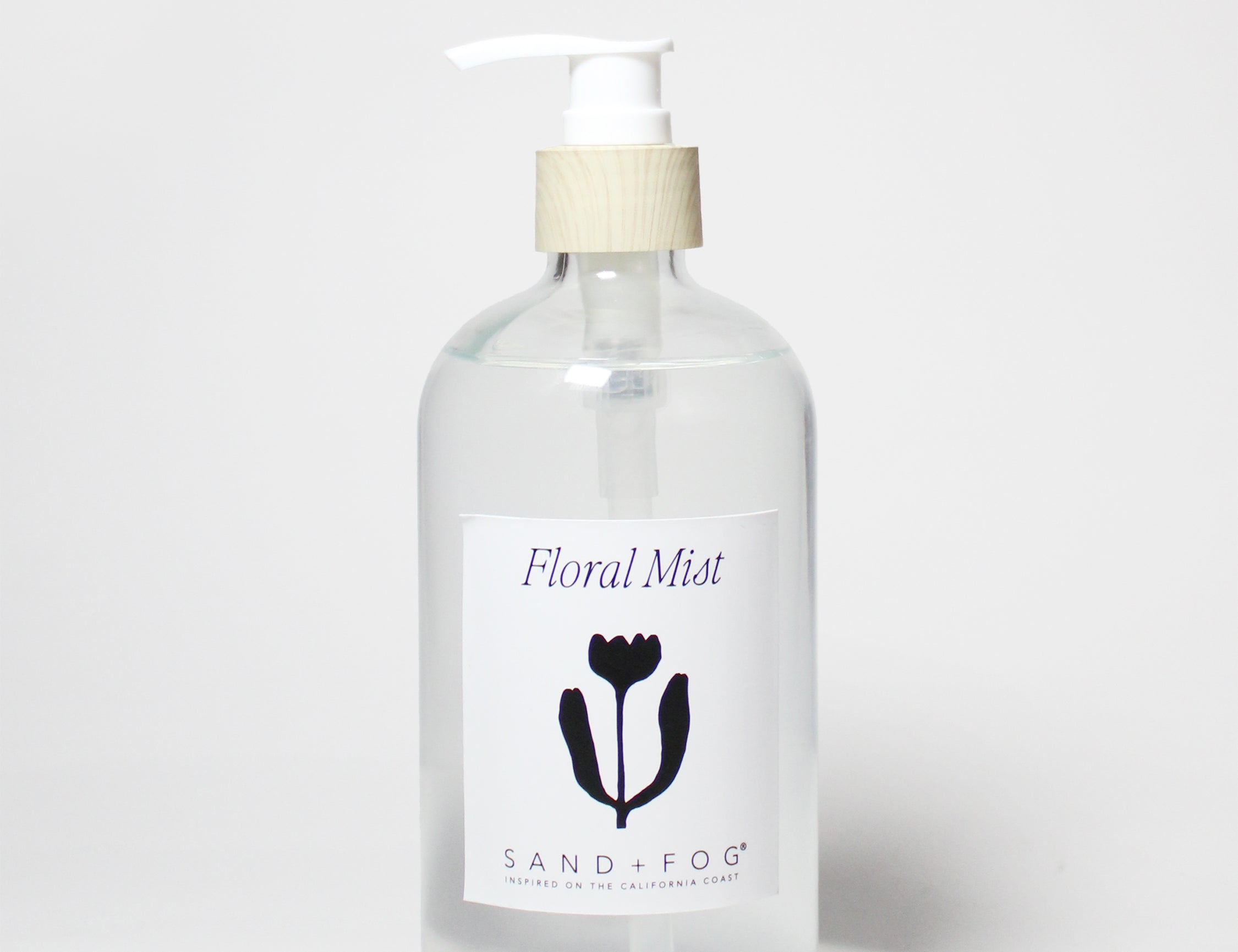 Liquid hand soap bottle with white pump, clear glass, Floral Mist label.
