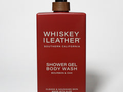 Red body wash bottle with black pump, labeled Whiskey Leather shower gel bourbon & oak